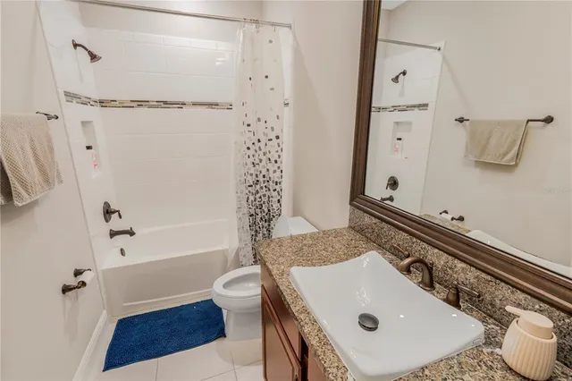 a living room with furniture and large windows