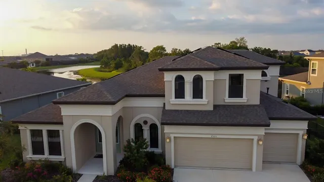 an aerial view of a house with garden space and street view