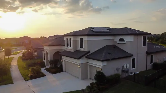 an aerial view of a house with a garden and swimming pool