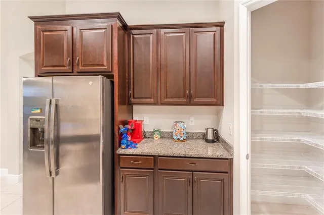 a kitchen with a refrigerator and cabinets