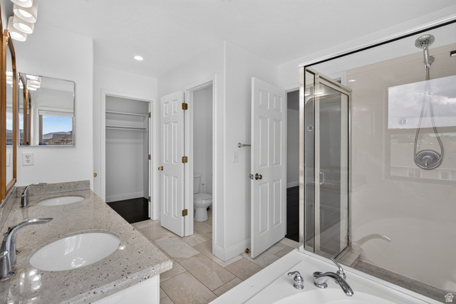 2223 North Pointe Meadow Loop Lehi, UT 84048 - Photo 22 of 56 Spacious bathroom featuring a dual vanity with light-toned countertops, two inset sinks, and chrome faucets
