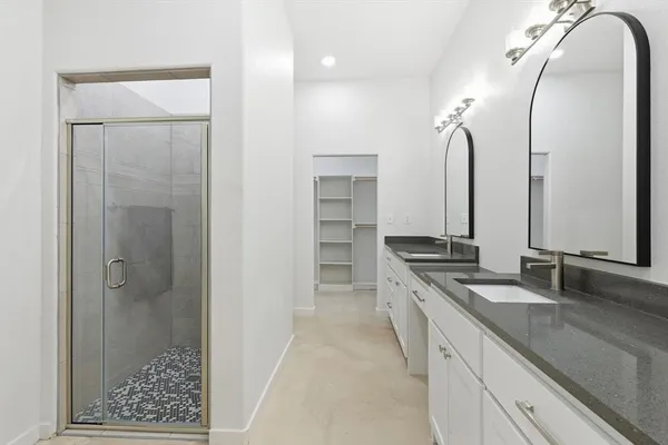 a bathroom with a double vanity sink and a mirror