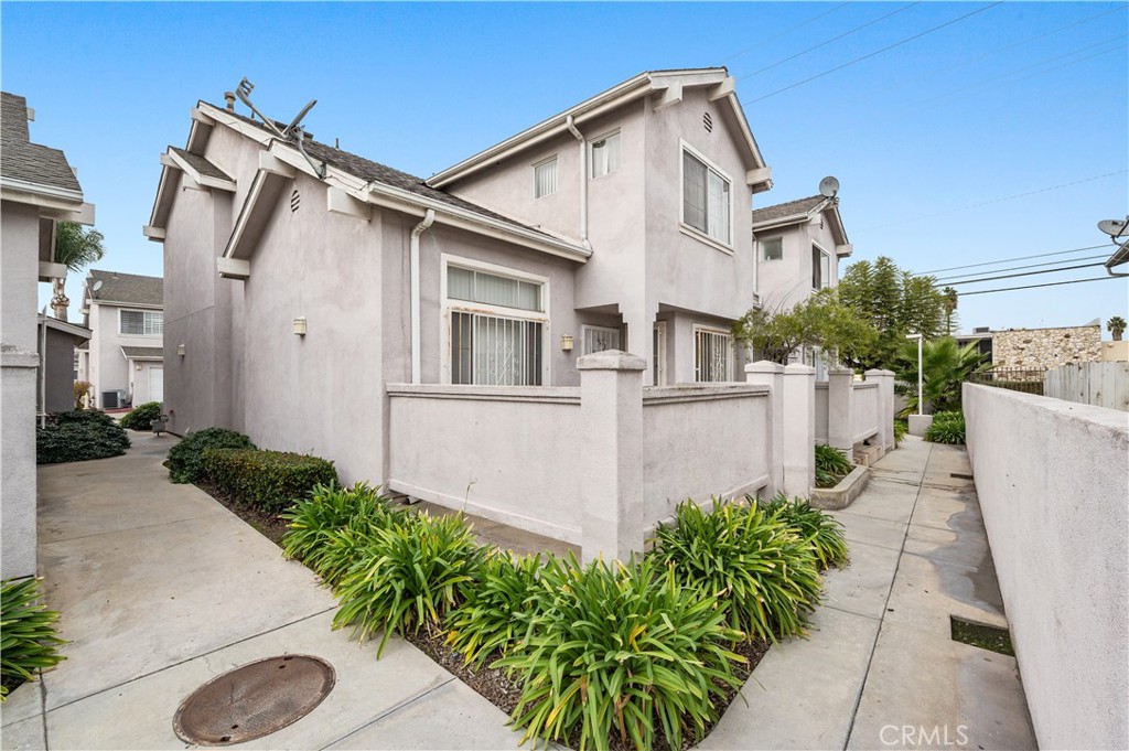 820 West Compton Boulevard, Unit 16 Compton, CA 90220 - Photo 1 of 1 front view of a house with a yard