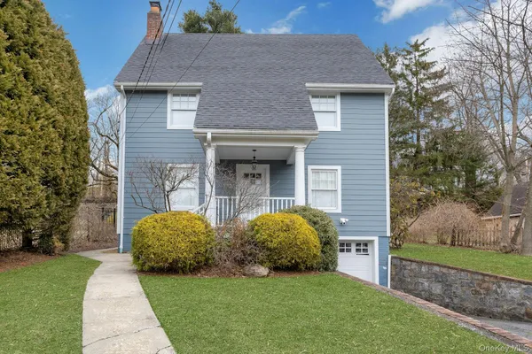 a view of a house with garden and yard