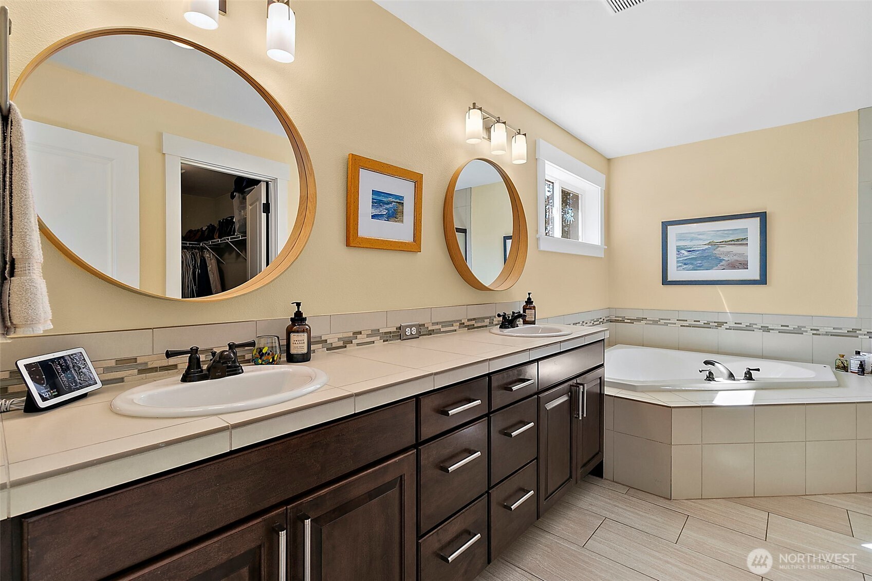 4917 Northeast 8th Street Renton, WA 98059 - Photo 21 of 37 a bathroom with a double vanity sink and a mirror