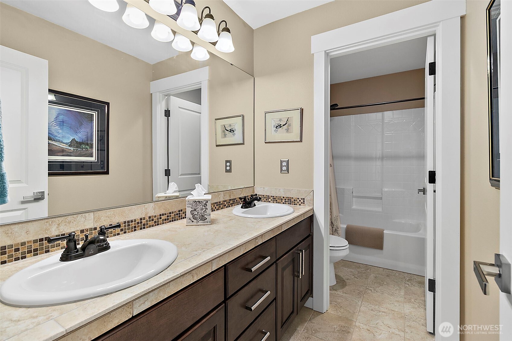 4917 Northeast 8th Street Renton, WA 98059 - Photo 25 of 37 a bathroom with a sink double vanity and a toilet