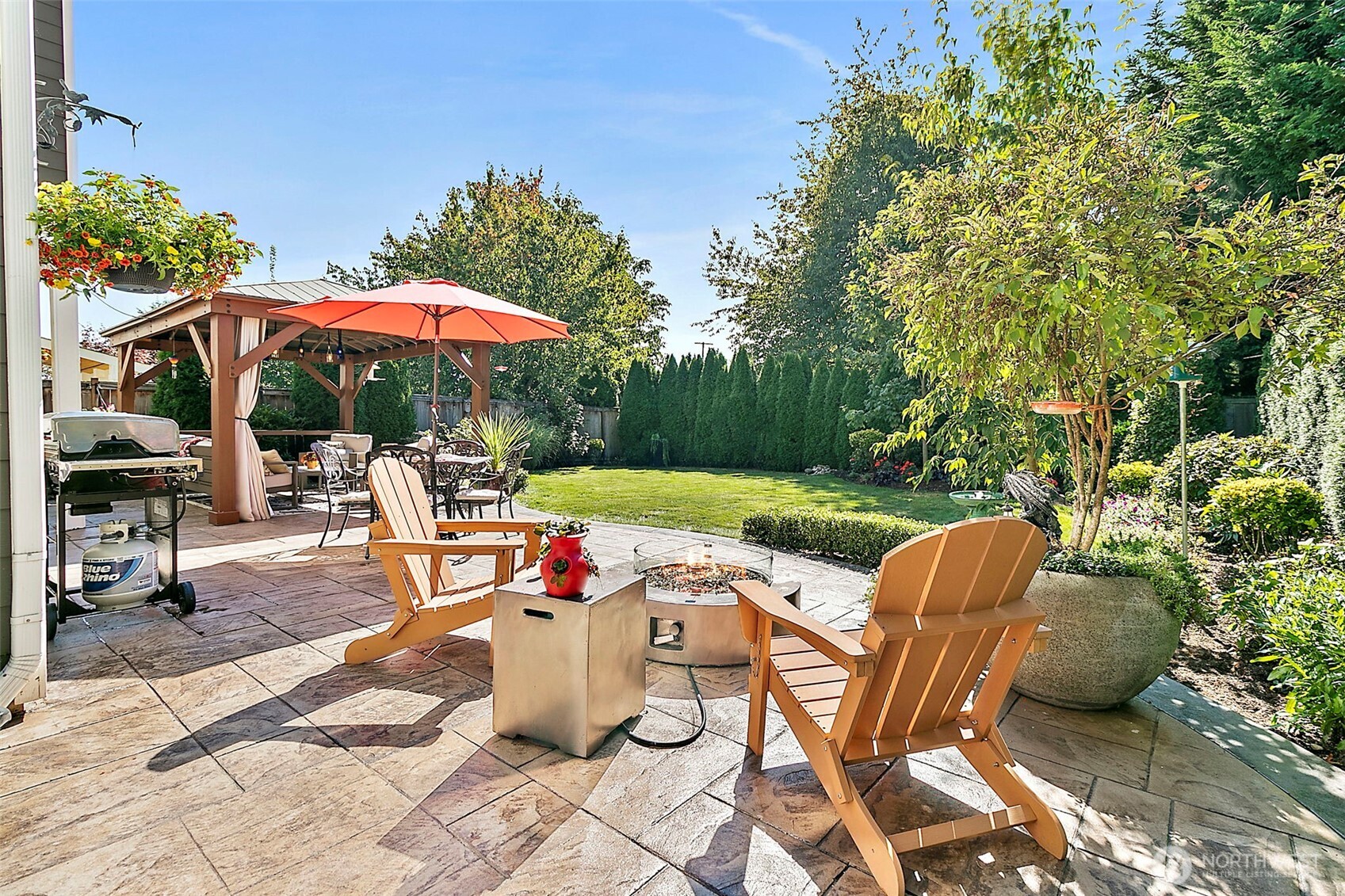 4917 Northeast 8th Street Renton, WA 98059 - Photo 32 of 37 a view of backyard with outdoor seating a patio and plants