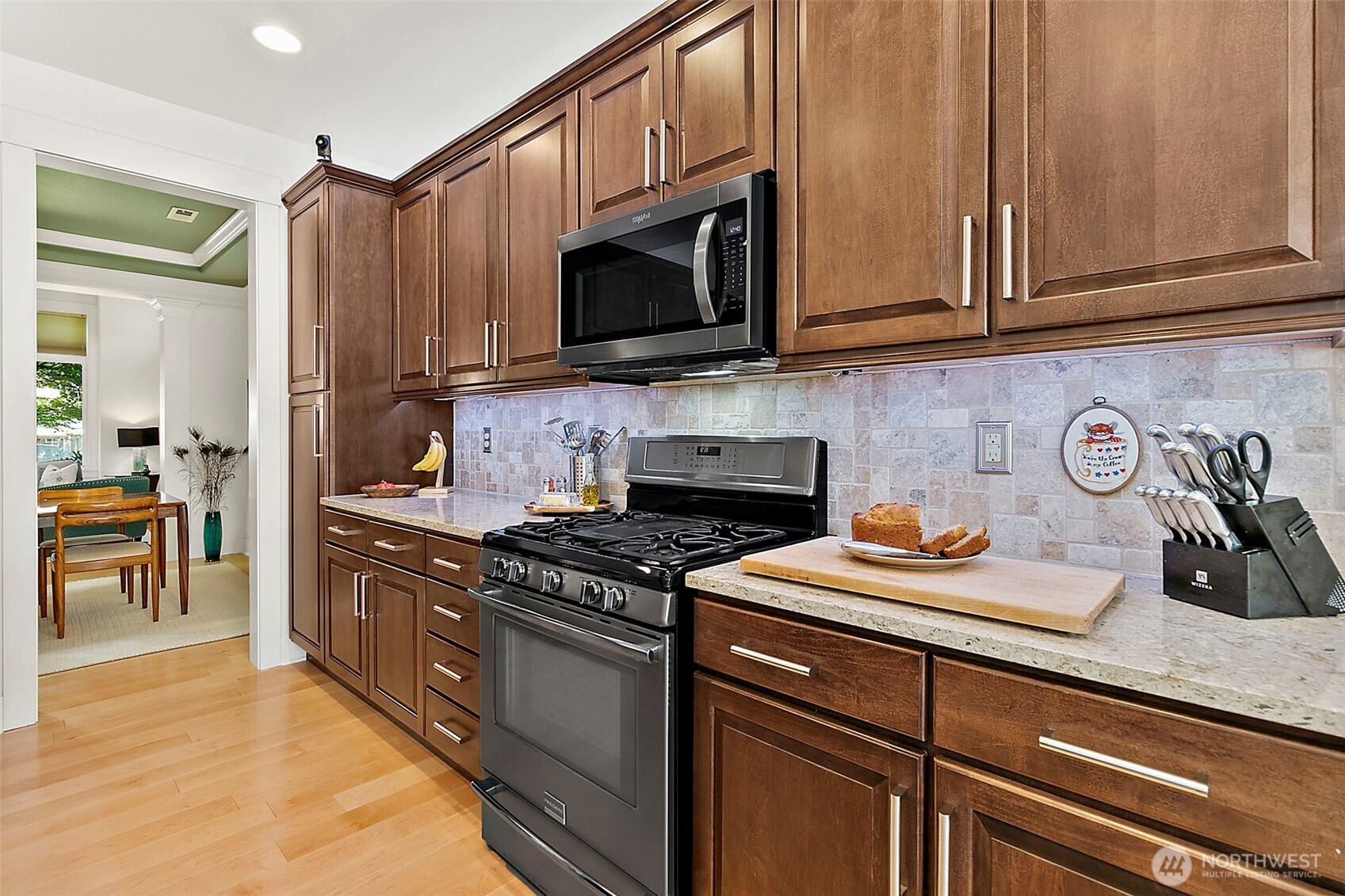 4917 Northeast 8th Street Renton, WA 98059 - Photo 9 of 37 a kitchen with stainless steel appliances granite countertop a sink stove and microwave