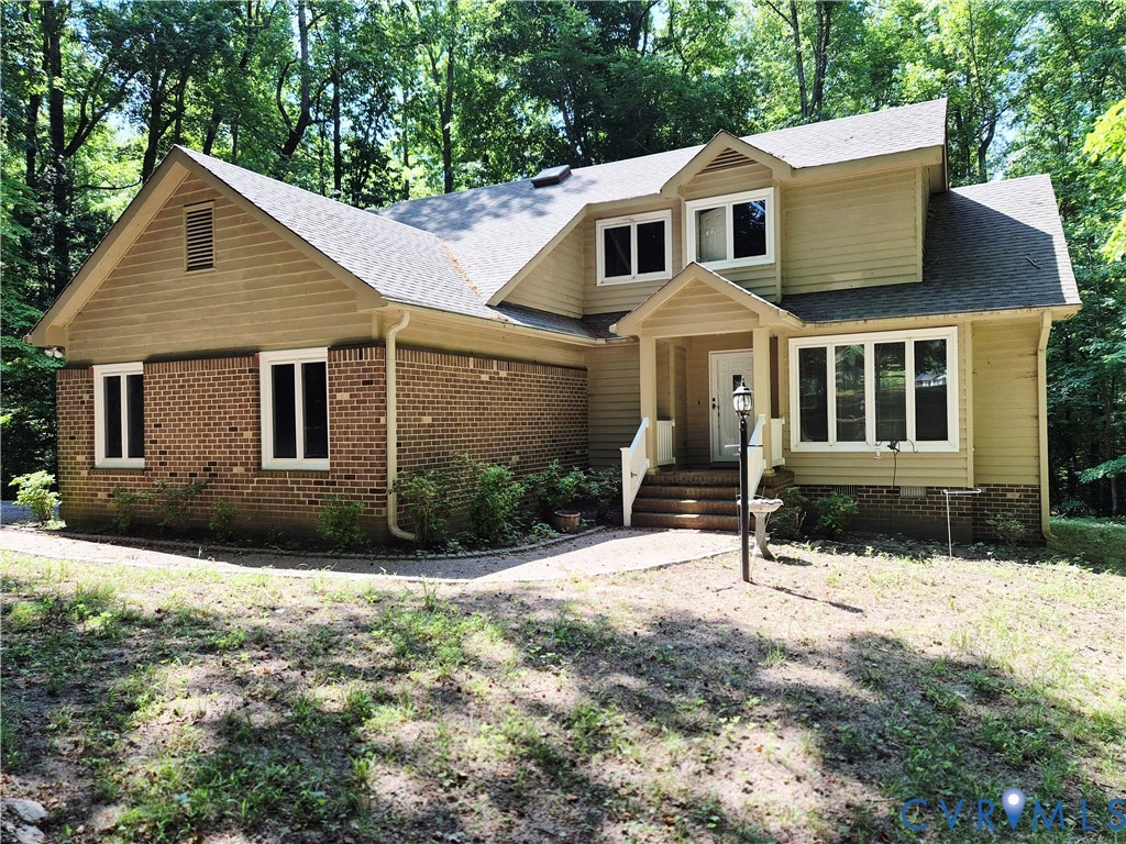 4099 Doe Run Road Hopewell, VA 23860 - Photo 1 of 35 a front view of a house with a yard covered in snow