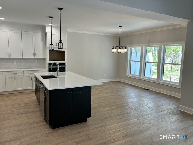35 Village Circle, Unit 35 Hamden, CT 06514 - Photo 4 of 14 a kitchen with a sink cabinets and wooden floor
