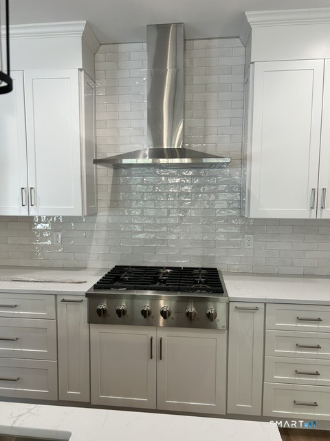 35 Village Circle, Unit 35 Hamden, CT 06514 - Photo 7 of 14 a kitchen with granite countertop a stove and a cabinets
