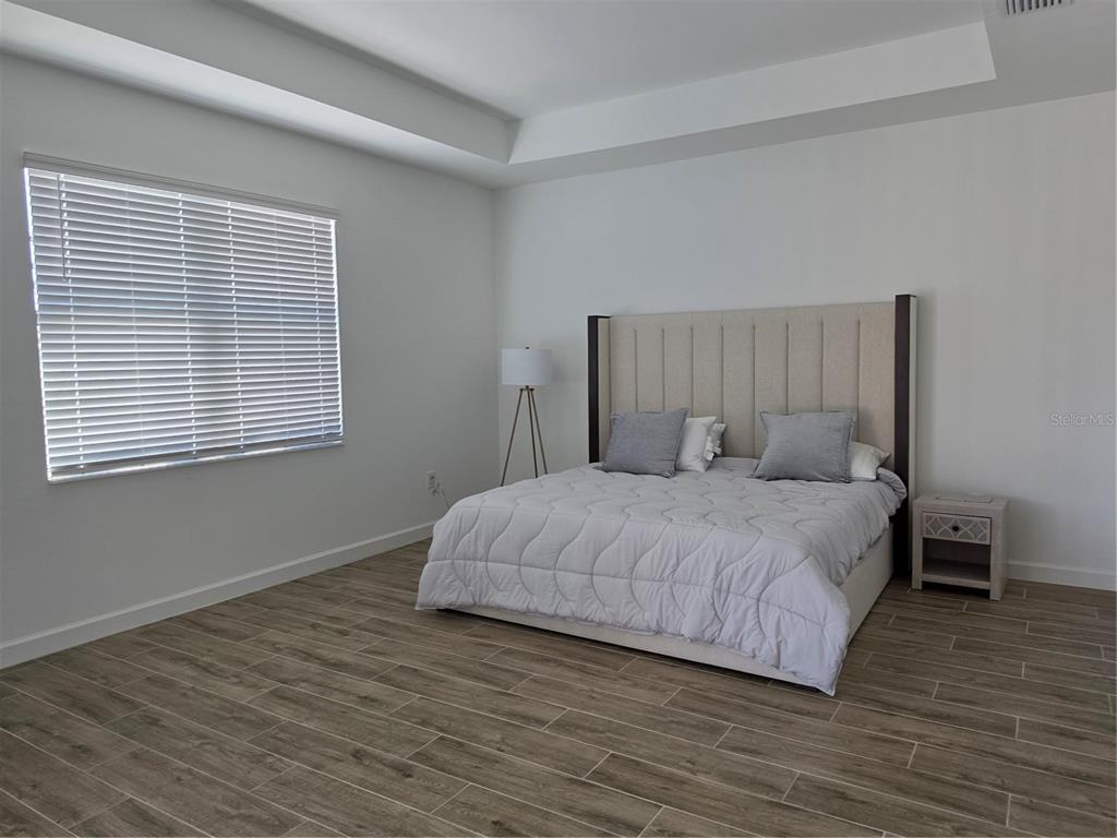 18334 Ridgeline Drive Estero, FL 33928 - Photo 9 of 30 a bedroom with a bed and a window