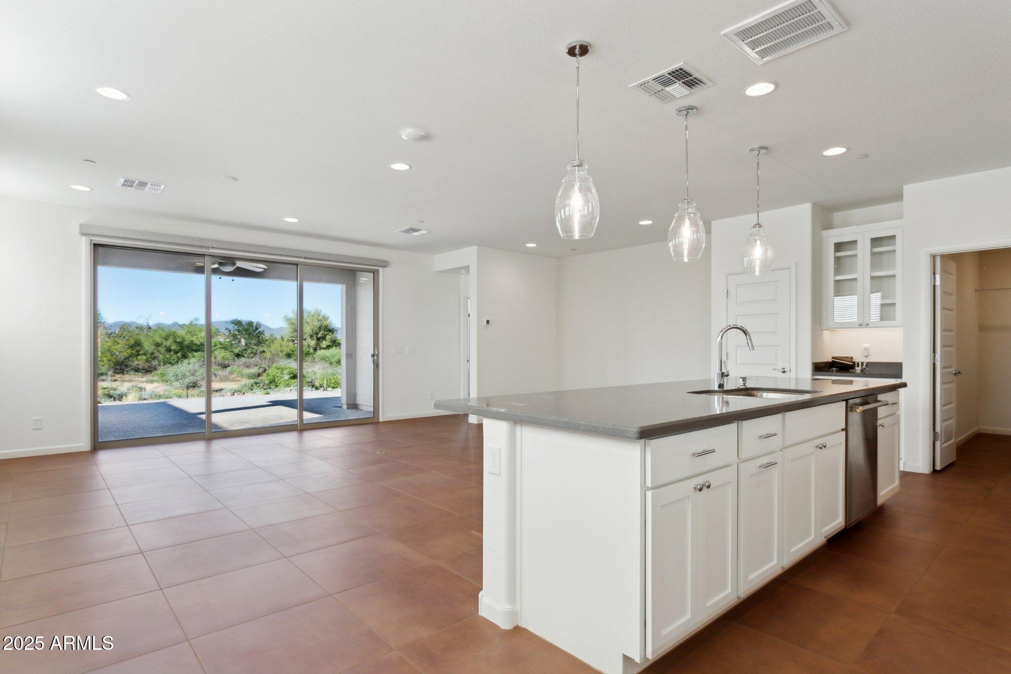 18324 East Spring Valley Court Rio Verde, AZ 85263 - Photo 11 of 39 a large kitchen with kitchen island a stove a sink a center island and windows