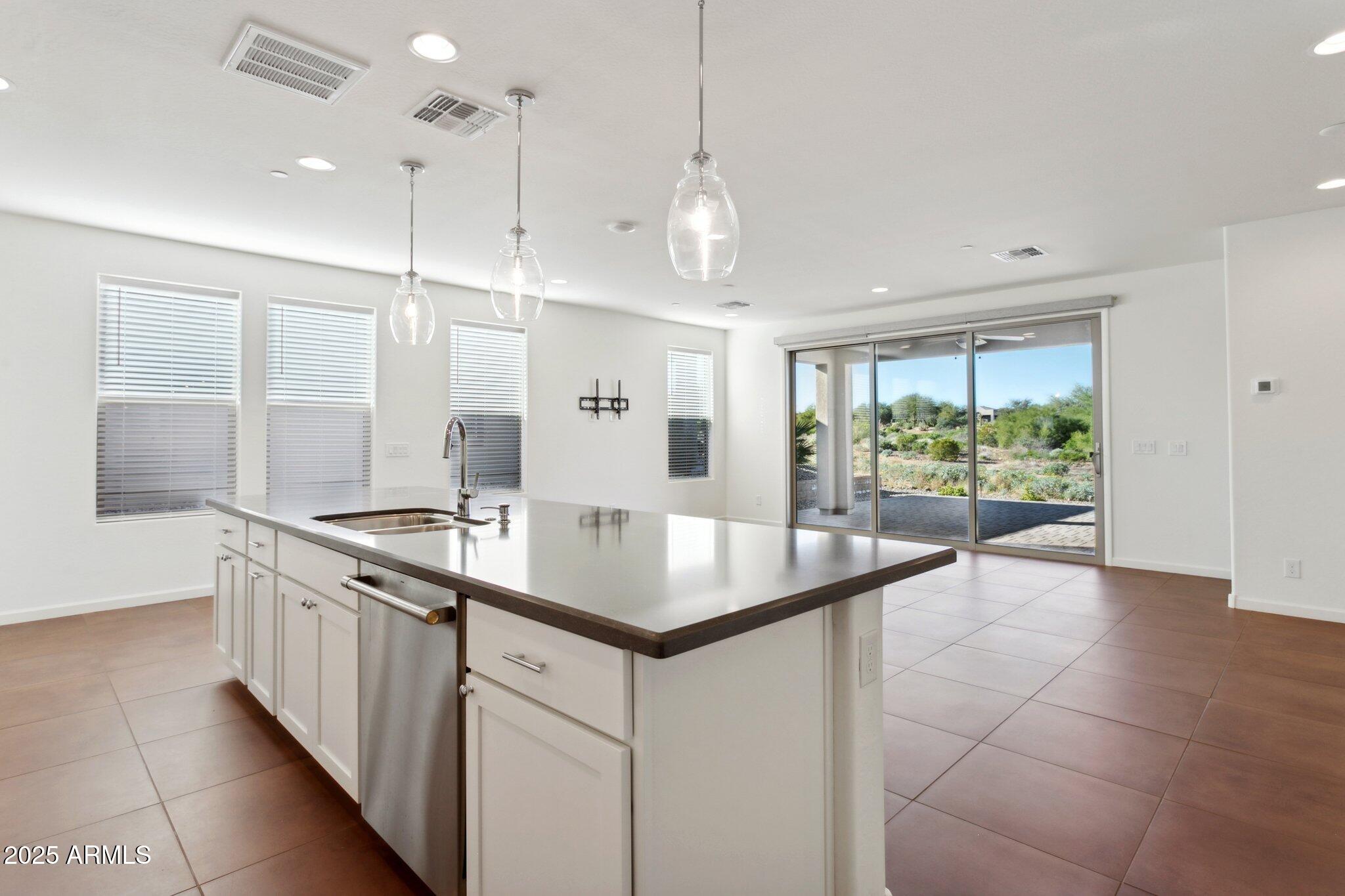 18324 East Spring Valley Court Rio Verde, AZ 85263 - Photo 15 of 39 a kitchen with stainless steel appliances granite countertop a sink and a large window