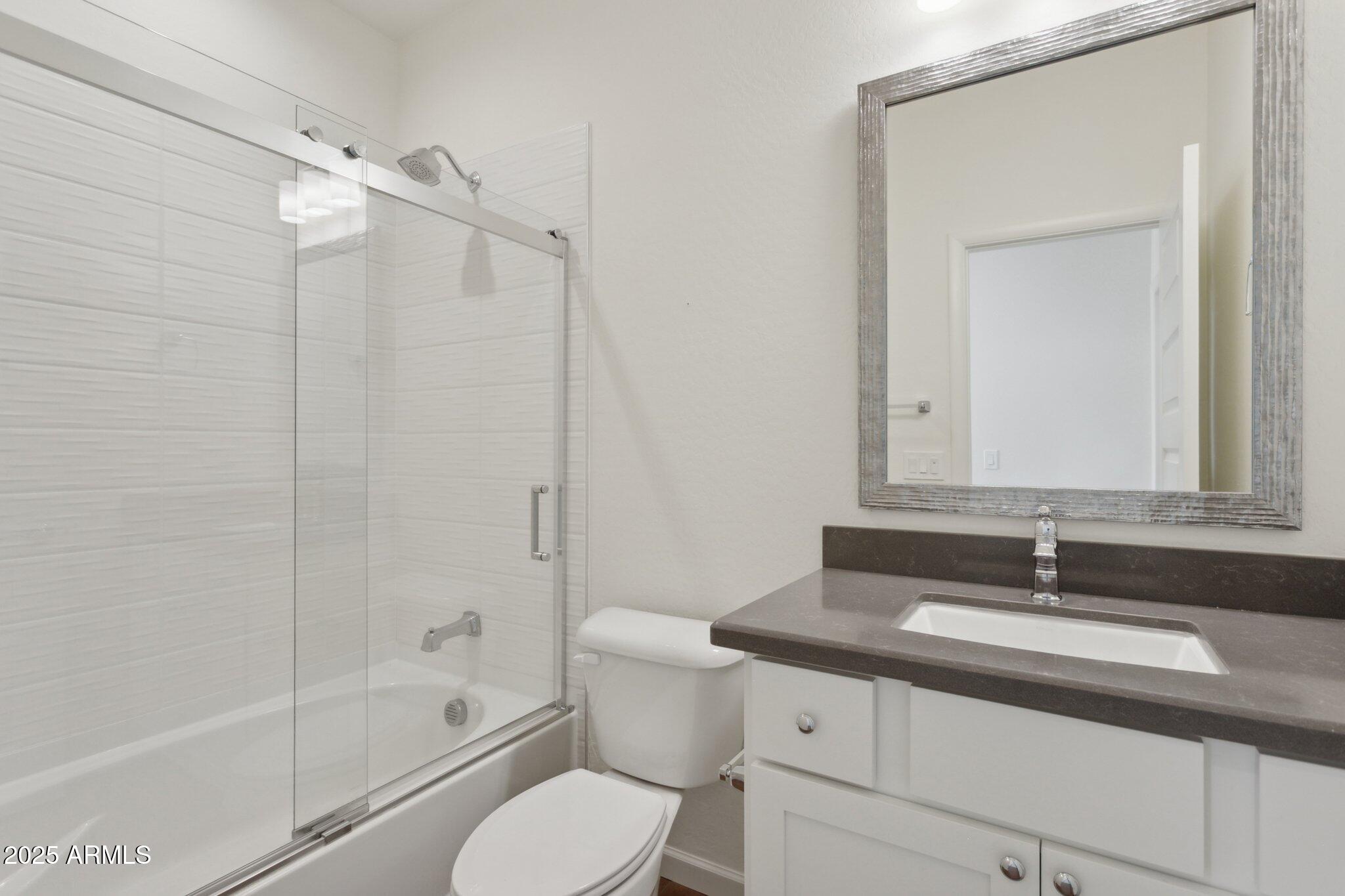 18324 East Spring Valley Court Rio Verde, AZ 85263 - Photo 24 of 39 a bathroom with a sink toilet vanity and shower