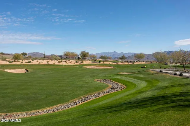 a view of a grassy field with an ocean view