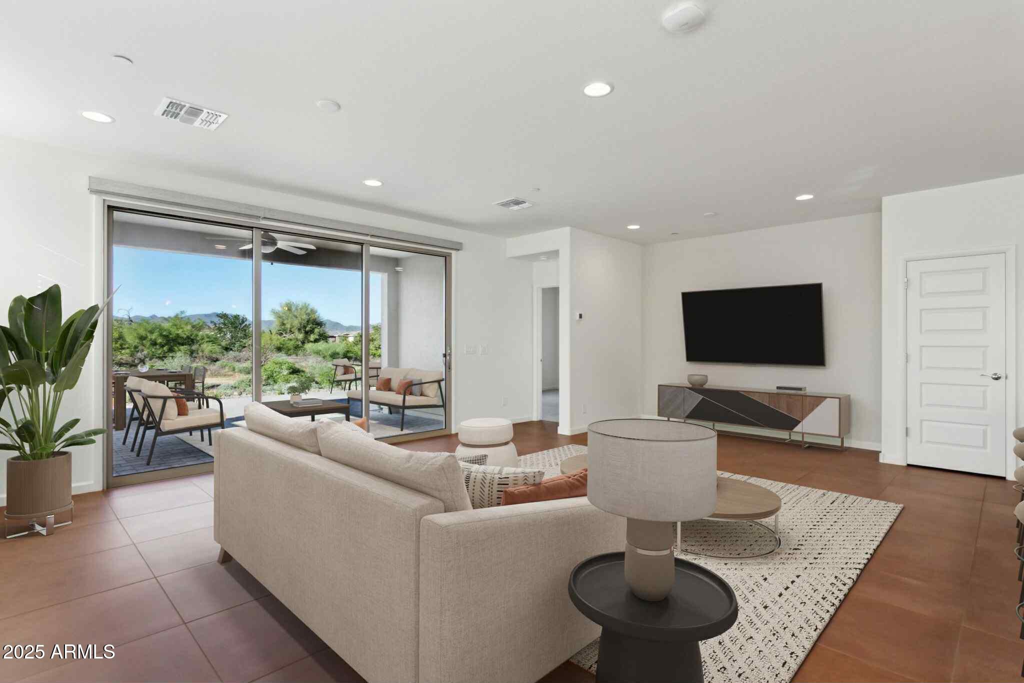 18324 East Spring Valley Court Rio Verde, AZ 85263 - Photo 4 of 39 a living room with furniture a flat screen tv and a large window