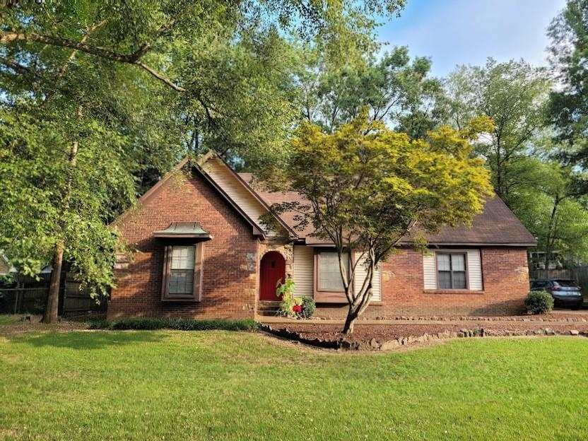 This low-maintenance brick home offers stone accents and wood trim and is situated on a great sized lot and nestled in nature.