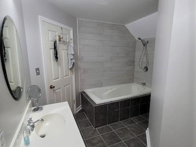5285 Orangewood Road Memphis, TN 38134 - Photo 20 of 25 The full bathroom upstairs has also undergone a recent renovation and includes a whirlpool tub with shower, a new vanity, tiles, and lighting, and fresh paint too!