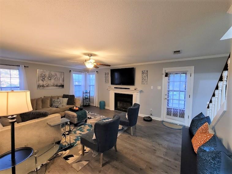 5285 Orangewood Road Memphis, TN 38134 - Photo 5 of 25 The warm living room is great in size, features new Pergo laminate wood flooring, a fireplace with mantle, fresh paint color, a storage closet, and offers entry to the rear patio, the kitchen, and staircase.