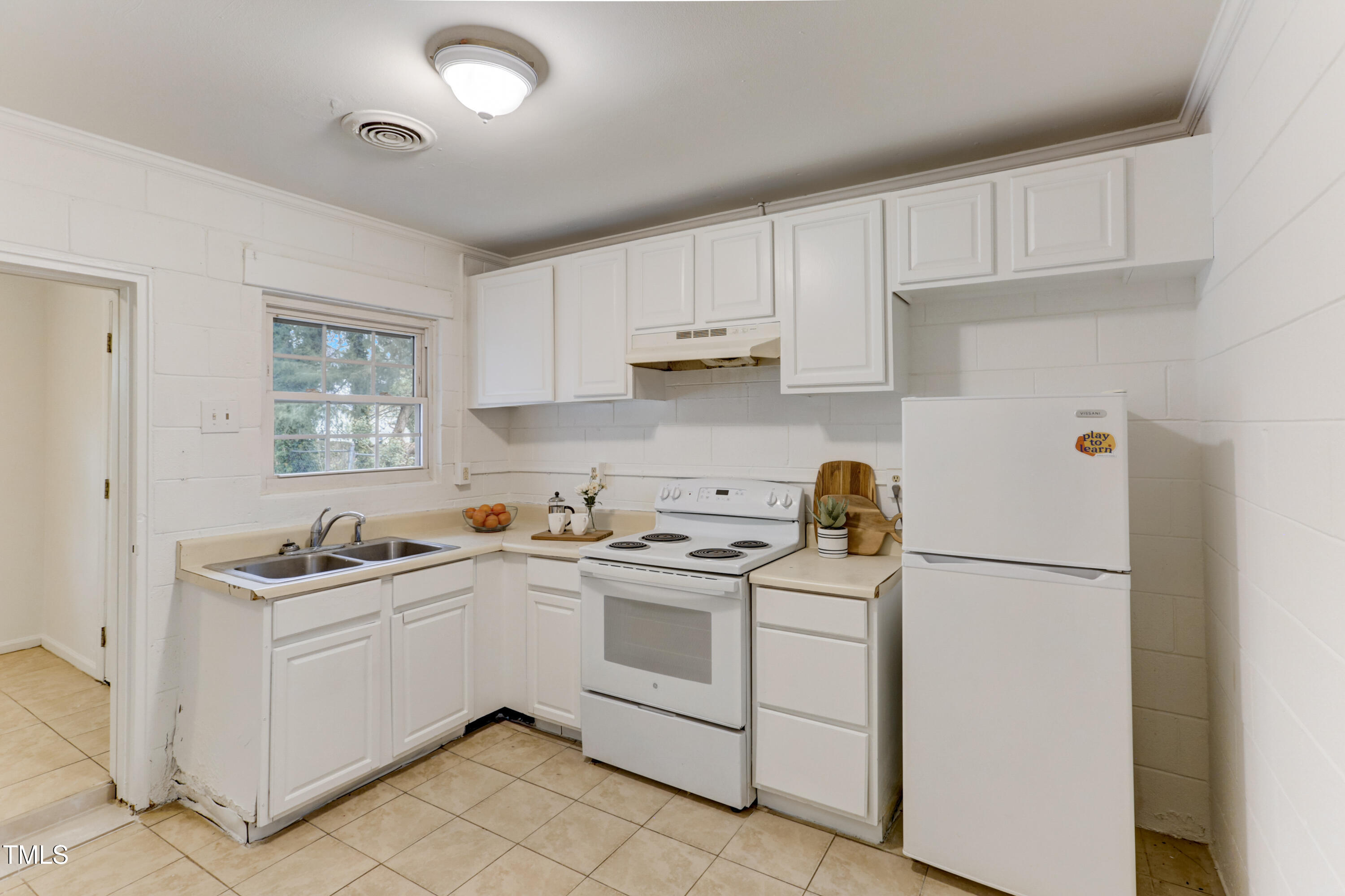 830 Lenoir Street Raleigh, NC 27601 - Photo 8 of 15 a kitchen with white cabinets and white appliances