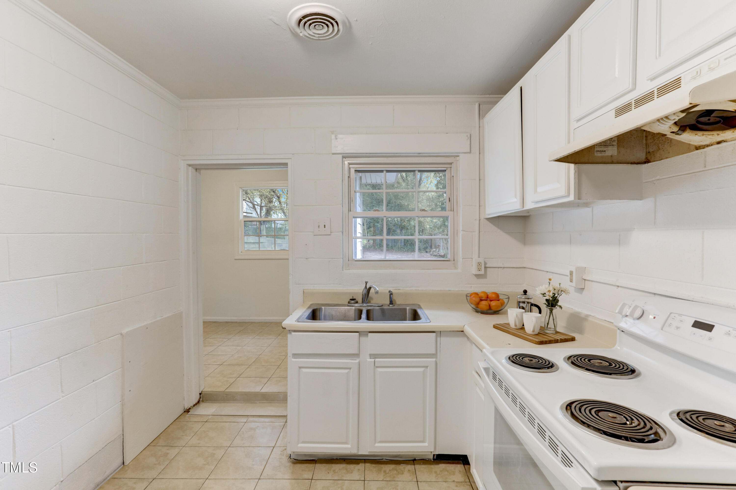 830 Lenoir Street Raleigh, NC 27601 - Photo 9 of 15 a kitchen with a sink stove and white cabinets