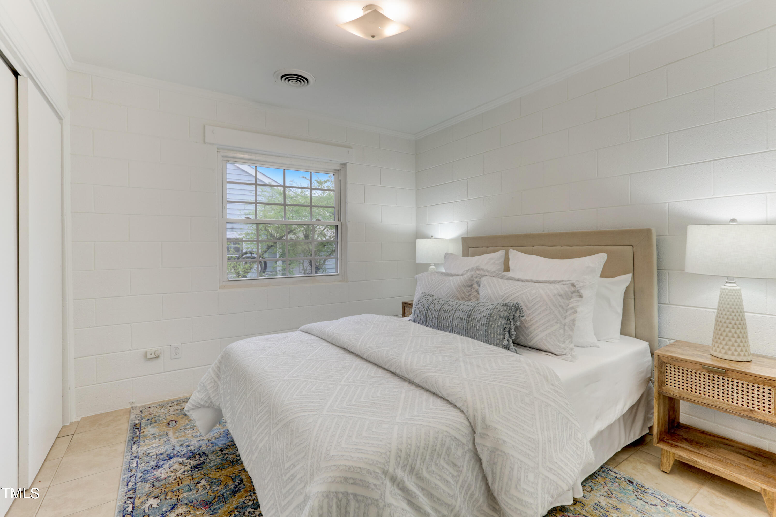 830 Lenoir Street Raleigh, NC 27601 - Photo 10 of 15 a bedroom with a bed and a window
