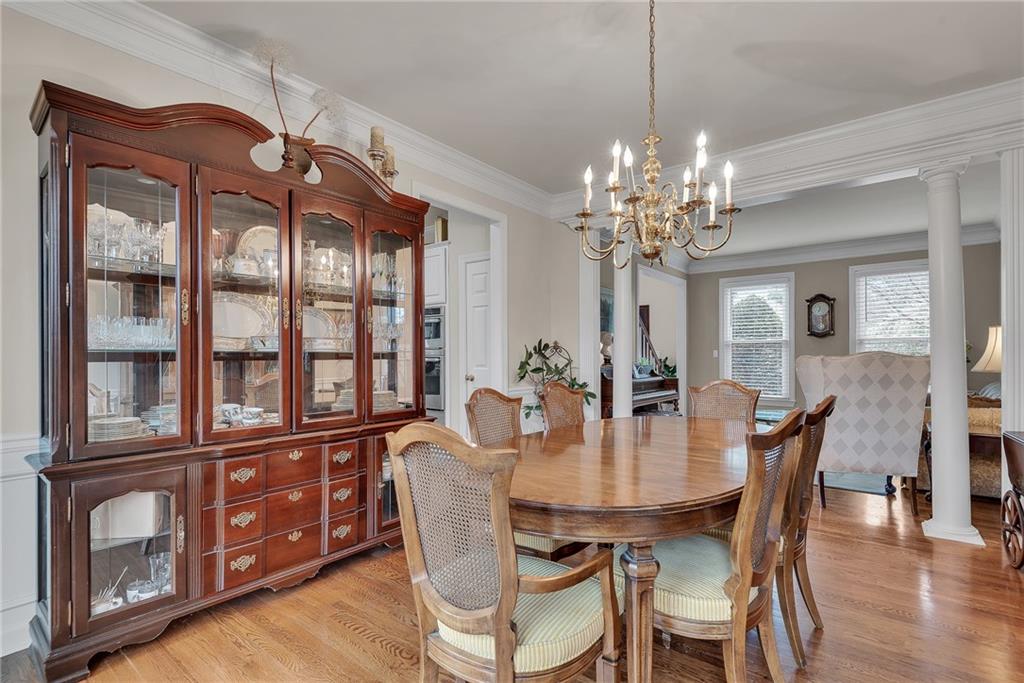 520 Fawn Run Alpharetta, GA 30005 - Photo 13 of 65 a dining room with furniture a chandelier and wooden floor