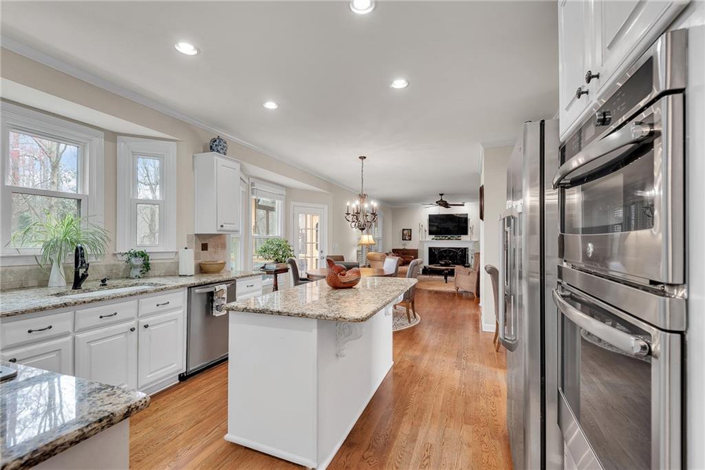 520 Fawn Run Alpharetta, GA 30005 - Photo 15 of 65 a kitchen with stainless steel appliances granite countertop a refrigerator a sink dishwasher a oven with white cabinets and wooden floor