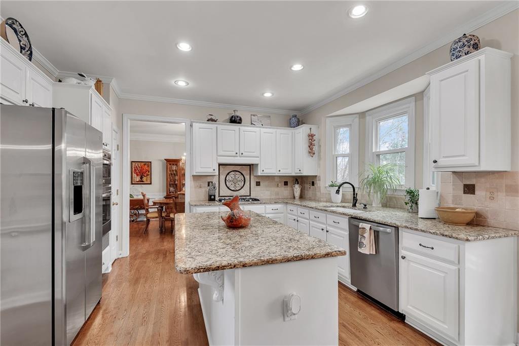 520 Fawn Run Alpharetta, GA 30005 - Photo 16 of 65 a kitchen with a refrigerator a sink and cabinets