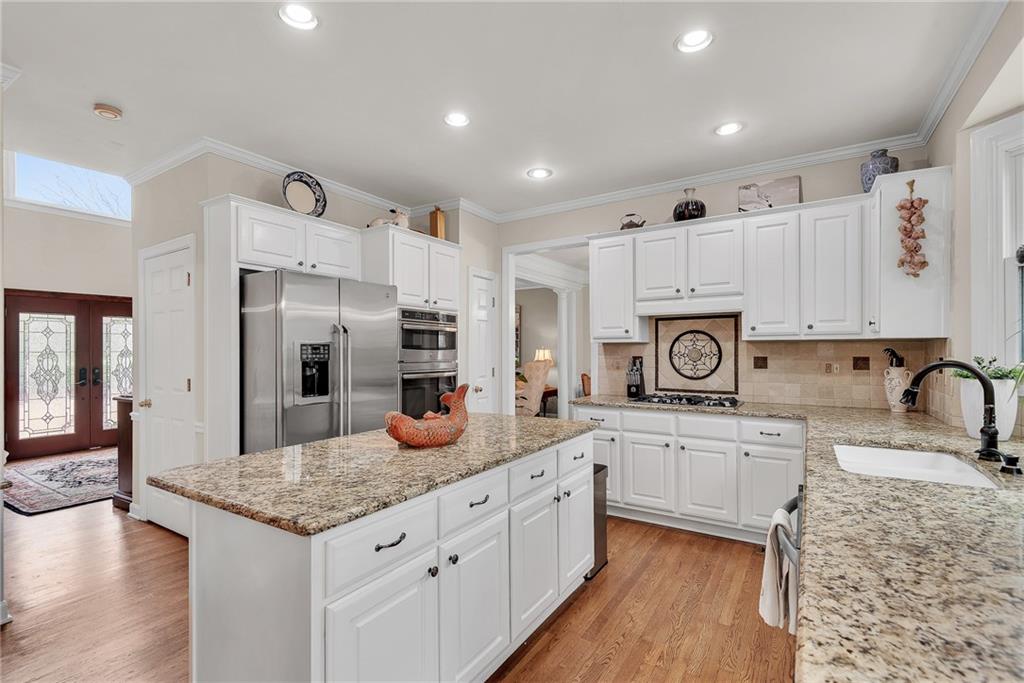 520 Fawn Run Alpharetta, GA 30005 - Photo 17 of 65 a kitchen with stainless steel appliances granite countertop a sink stove and refrigerator