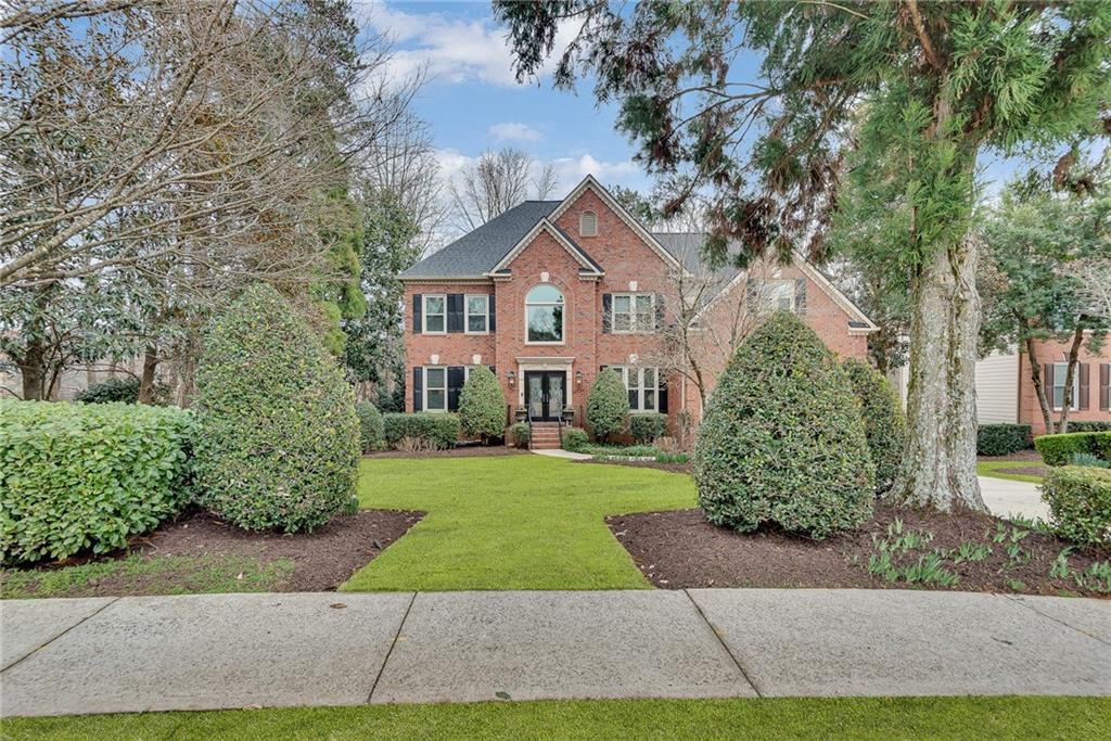 520 Fawn Run Alpharetta, GA 30005 - Photo 2 of 65 a front view of a house with yard and green space