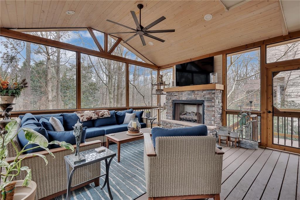 520 Fawn Run Alpharetta, GA 30005 - Photo 24 of 65 a living room with furniture a fireplace and a flat screen tv