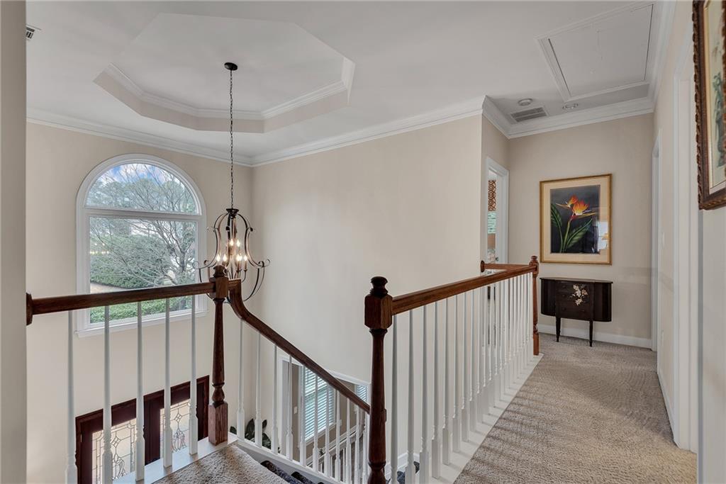 520 Fawn Run Alpharetta, GA 30005 - Photo 30 of 65 a view of a hallway to a livingroom with wooden floor and stairs