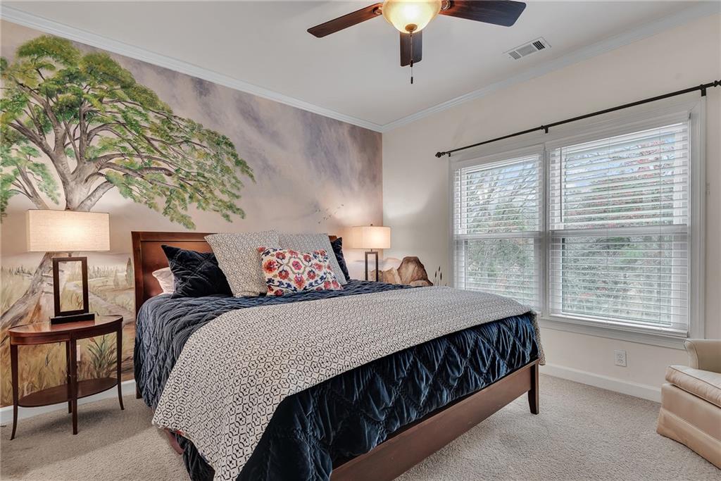 520 Fawn Run Alpharetta, GA 30005 - Photo 32 of 65 a bedroom with a large bed and a chandelier fan