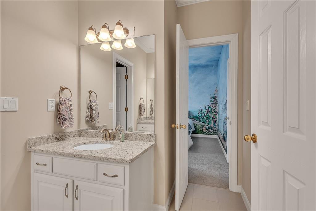 520 Fawn Run Alpharetta, GA 30005 - Photo 36 of 65 a bathroom with a granite countertop sink a light fixture and a mirror