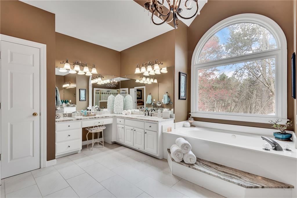 520 Fawn Run Alpharetta, GA 30005 - Photo 44 of 65 a bathroom with a tub sink and view of living room