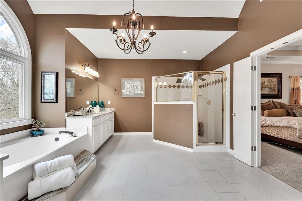 520 Fawn Run Alpharetta, GA 30005 - Photo 45 of 65 a large white kitchen with a refrigerator and chandelier