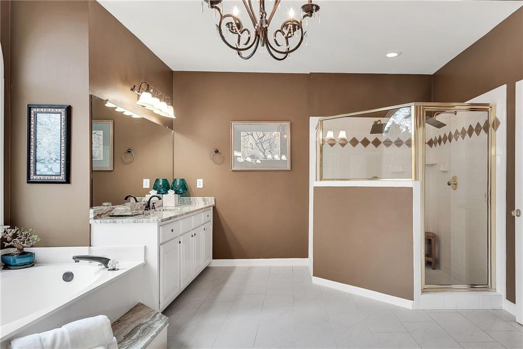 520 Fawn Run Alpharetta, GA 30005 - Photo 46 of 65 a bathroom with a sink a mirror and a shower