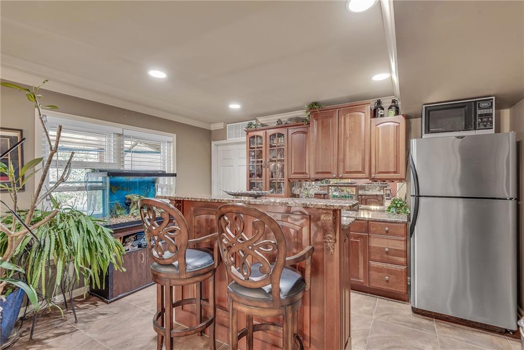 520 Fawn Run Alpharetta, GA 30005 - Photo 48 of 65 a kitchen with stainless steel appliances granite countertop a refrigerator a sink a stove and white cabinets