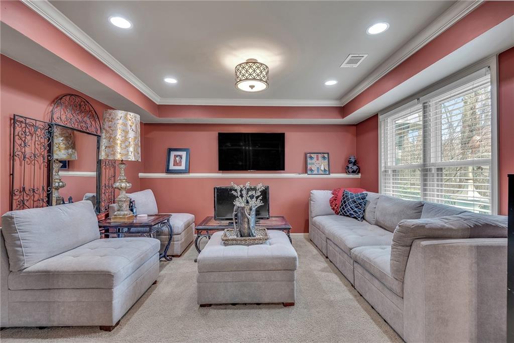 520 Fawn Run Alpharetta, GA 30005 - Photo 51 of 65 a living room with furniture and a flat screen tv