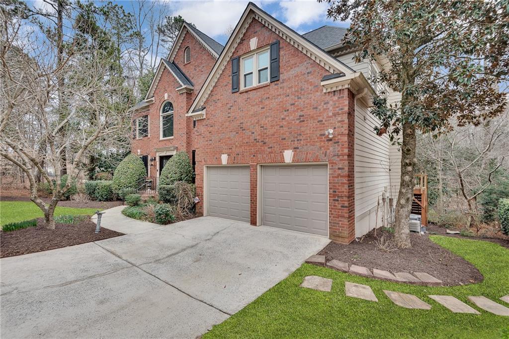 520 Fawn Run Alpharetta, GA 30005 - Photo 65 of 65 a front view of a house with a yard and garage