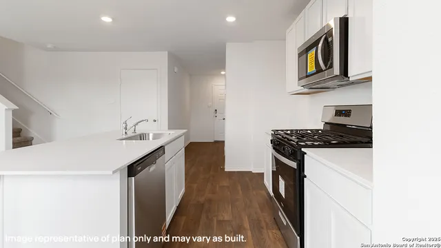 a kitchen with granite countertop a sink and a stove top oven