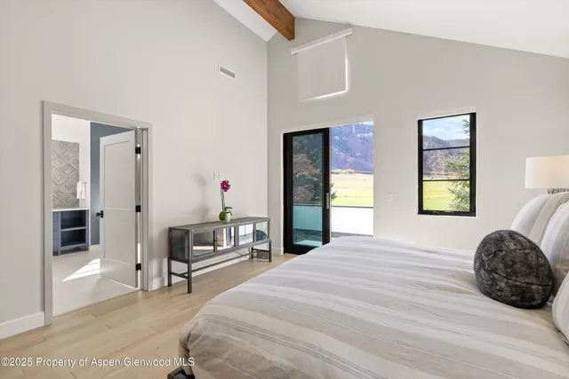 a bedroom with a bed and a chair