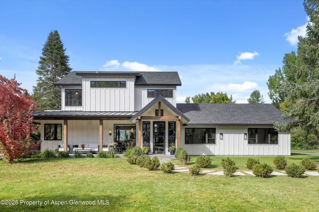 a front view of a house with a garden and porch