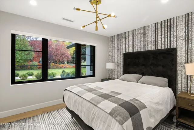 a bedroom with two beds and a large window