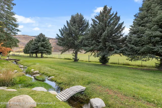 a view of a house with pool and a fire pit