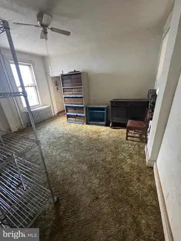 a view of a livingroom with furniture and staircase
