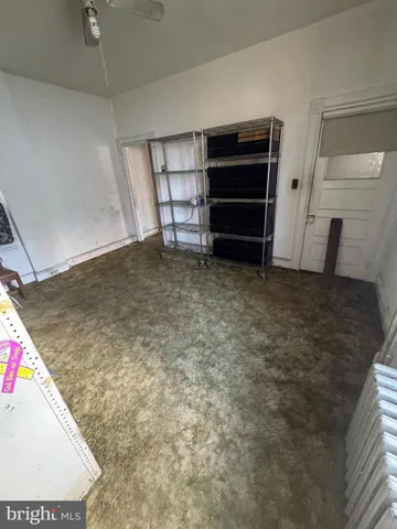 a view of a room with furniture and empty shelves