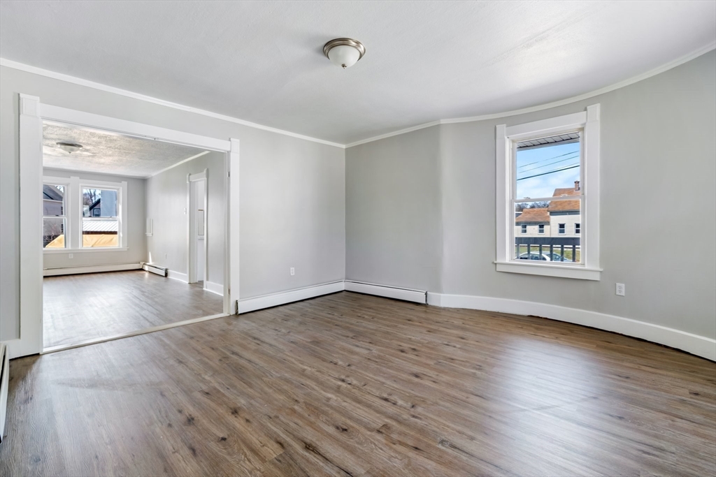 142 Spruce Street Winchendon, MA 01475 - Photo 17 of 34 a view of an empty room with window and wooden floor